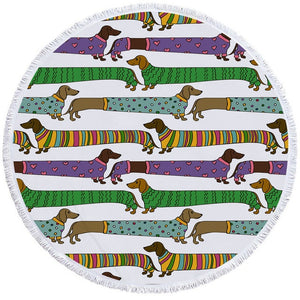 Image of a round dachshund towel with dachshunds wearing sweaters on white background