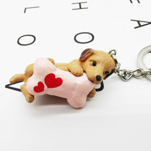 Image of a super-cute Dachshund keychain featuring the cutest Dachshund with a bone with hearts design.