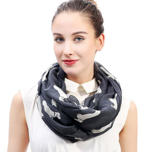 Image of a girl wearing a beautful Dachshund scarf in the color dark grey with infinite Dachshunds design