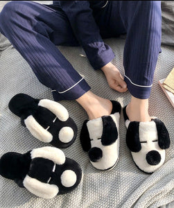 Image of a person wearing Dalmatian slippers in black and white