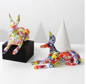 Image of two stunning multicolor doberman statues made of resin