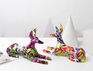 Image of two stunning multicolor doberman statues facing each other