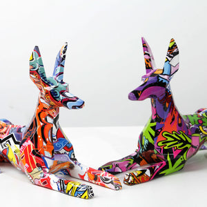 Image of two stunning multicolor doberman statues