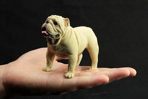Image of a cutest lifelike English Bulldog figurine standing in the hand of person made of PVC