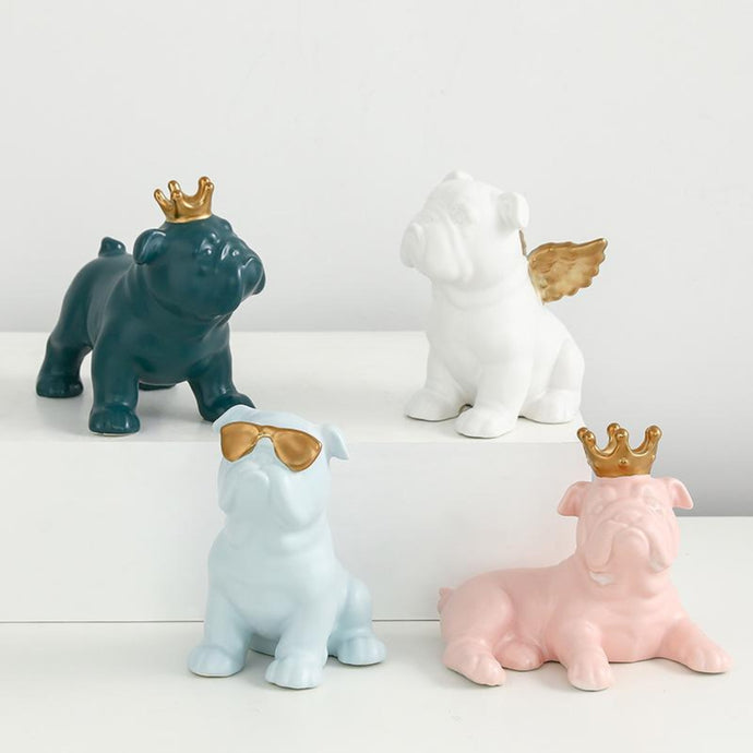 Image of four english bulldog statues made of ceramic in the color pink, light blue, teal, and white