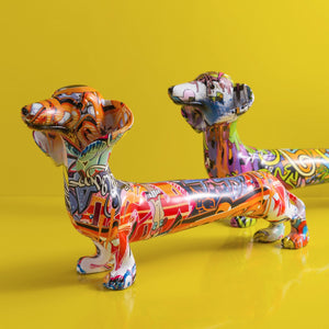 Image of two multicolor extra long graffiti dachshund statues