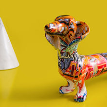 Load image into Gallery viewer, Image of a close view of multicolor extra long graffiti dachshund statue