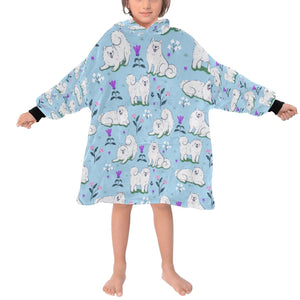 image of a kid wearing a samoyed blanket hoodie for kids - light blue