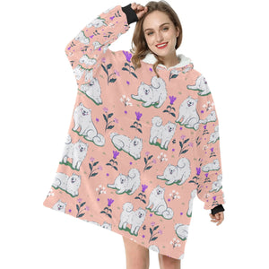 image of a woman wearing a samoyed blanket hoodie - peach 