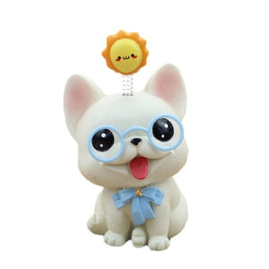 Image of a french bulldog bobblehead in the smiling White Frenchie babyface, wearing sky blue glasses, a matching bow-tie, with a bouncy yellow sun on his or her mind
