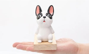 Image of a french bulldog door stopper on the hand of a person