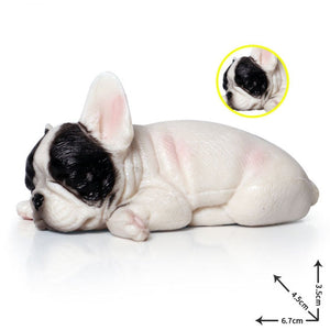 Image of a miniature sleeping on belly french bulldog figurine in the color pied black and white