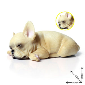 Image of a miniature sleeping on belly french bulldog figurine in the color pied white / cream