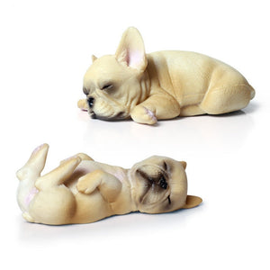 Image of two miniature sleeping on back and belly french bulldog figurines in the color white / cream