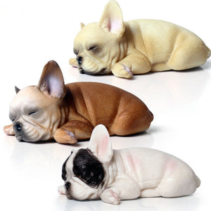 Image of three french bulldog figurines sleeping on belly
