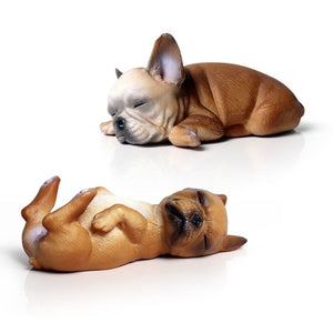 Image of two miniature sleeping on back and belly french bulldog figurines in the color fawn/tan