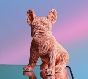 Image of a textured french bulldog statue made of resin in the color pink