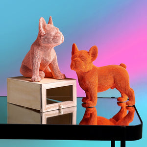 Image of two textured french bulldog statues made of resin in the color pink and orange