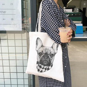 Image of a lady carrying french bulldog tote bag in fawn frenchie with cowboy bandana design