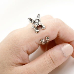Image of a finger wrap french bulldog ring on the finger of a person in the color Antique Silver