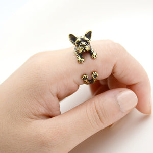 Image of a finger wrap french bulldog ring on the finger of a person in the color Antique Bronze