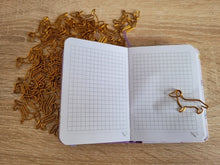 Load image into Gallery viewer, image of dachshund paperclips in use on a notebook