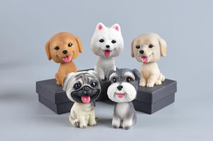 Image of five dog bobbleheads including Golden Retriever, Samoyed, Labrador, Pug, and Schnauzer bobblehead