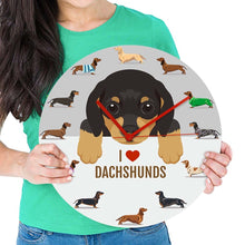 Load image into Gallery viewer, Image of a girl holding sausage dog wall clock