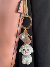 Load image into Gallery viewer, image of a bichon frise keychain hanging with a handbag