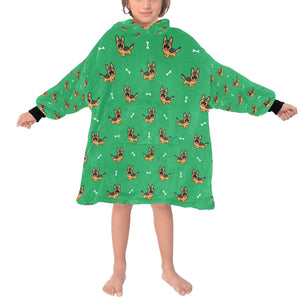 Image of a kid wearing a German shepherd blanket hoodie in green color with a white background - front view