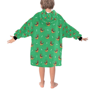 Image of a kid wearing a German shepherd blanket hoodie in green color with a white background - back view