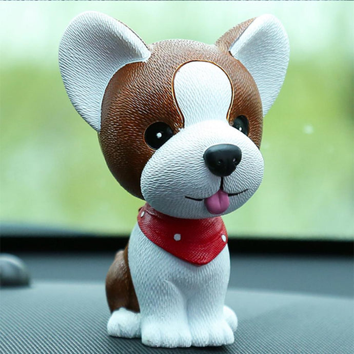 Image of a jack russell terrier bobblehead on a car dashboard