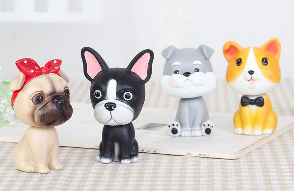 Image of four nodding bobbleheads shaped like a girl Pug, Boston Terrier, Miniature Schnauzer, and Corgi