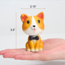 Load image into Gallery viewer, Image of a nodding Corgi bobblehead on the hand of a person