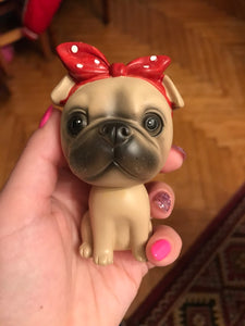 Image of a lady holding a pug bobbleheads