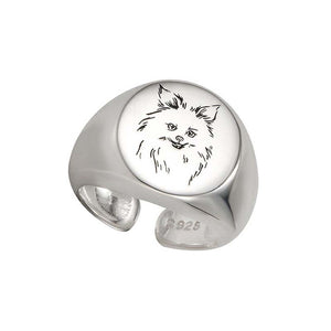Image of a stunning silver signet Pomeranian ring in smiling Pomeranian design