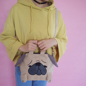 Image of a girl holding pug bag