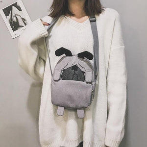 Image of a lady holding pug bag in the color Gray