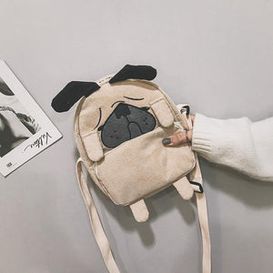 Image of a lady holding pug bag in the color Khaki