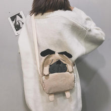 Load image into Gallery viewer, Back image of a lady holding pug messenger bag in the color Khaki