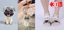 Load image into Gallery viewer, Image of pug gifts bundle with smiling pug bobblehead, pug socks, and pug keychain