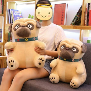 Image of a girl sitting on a couch with two Pug stuffed animals soft toys