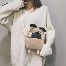 Load image into Gallery viewer, Image of a lady holding pug messenger bag in the color Khaki