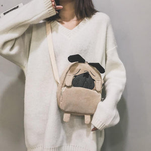 Image of a lady holding pug messenger bag in the color Khaki