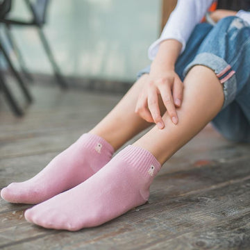 Image of a lady wearing ankle length pug socks