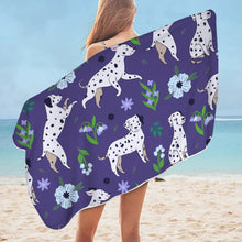 Load image into Gallery viewer, Image of a lady flaunting Dalmatian towel at the beach in purple flower garden Dalmatian design
