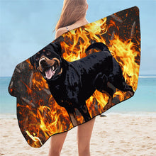 Load image into Gallery viewer, Image of a lady wearing rottweiler beach towel on the beach