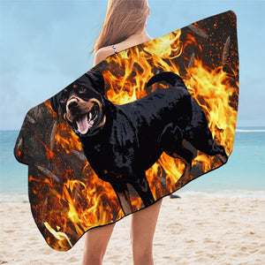 Image of a lady wearing rottweiler beach towel on the beach