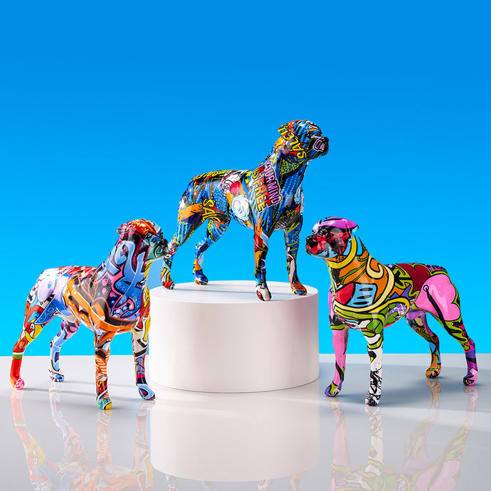 Image of three multicolor rottweiler statues