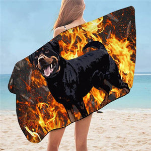 Image of a lady wearing rottweiler towel on the beach